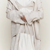 Modern Weaving Slim Elongated Tote Creme styled with neutral outfit showing soft leather drape and elongated shape