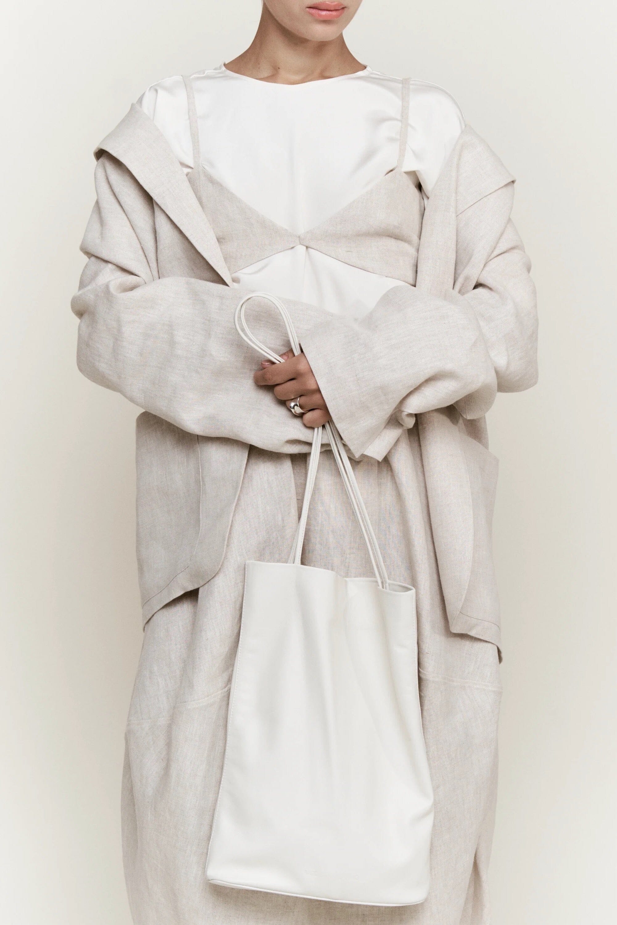 Modern Weaving Slim Elongated Tote Creme styled with neutral outfit showing soft leather drape and elongated shape