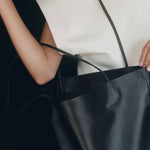 Modern Weaving Slim Lamb Sak Black worn on shoulder showing relaxed slouchy silhouette and lightweight structure