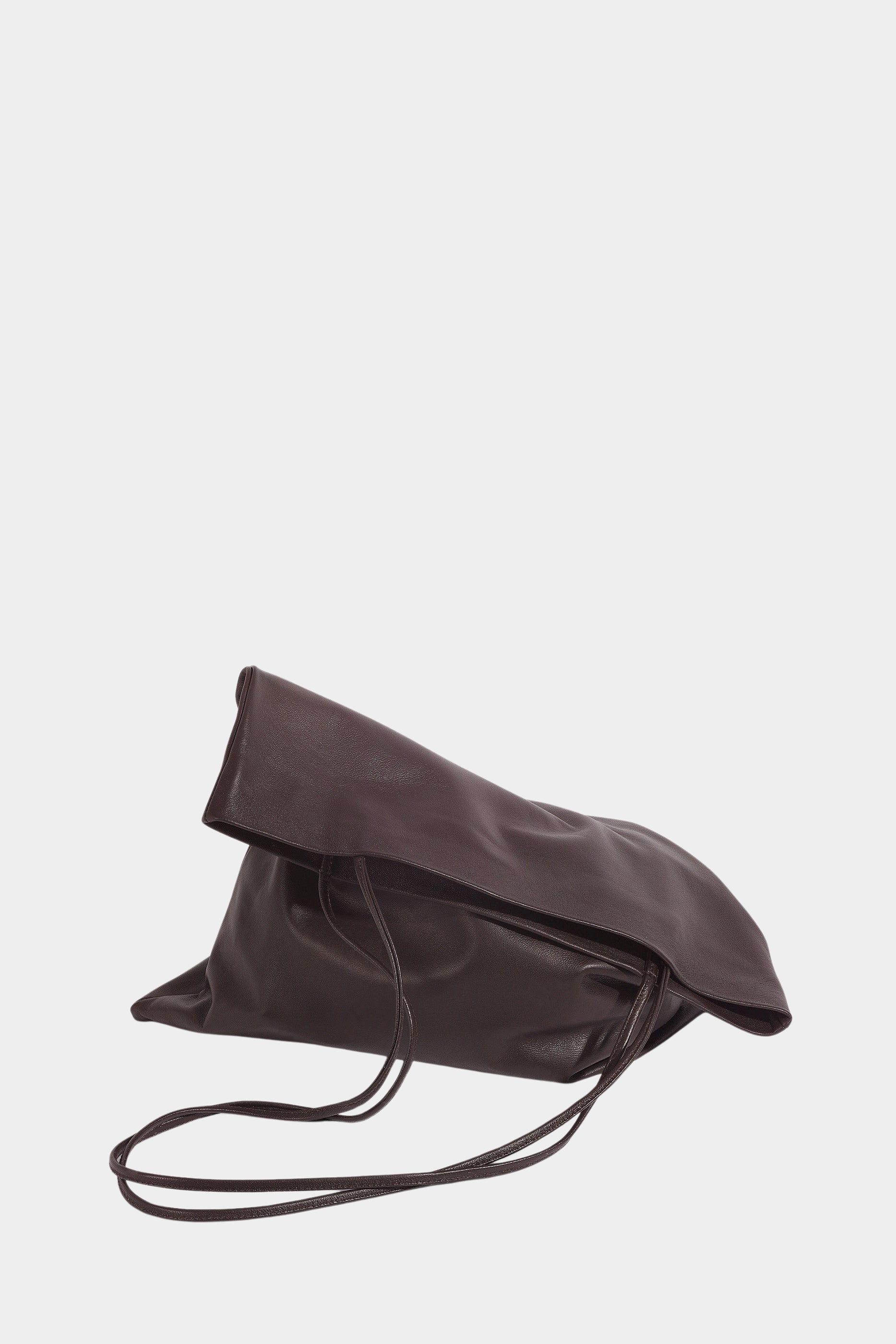 Braun leather Slim Lamb Sak lying on its side with its soft upper edge folded over and straps draped in front