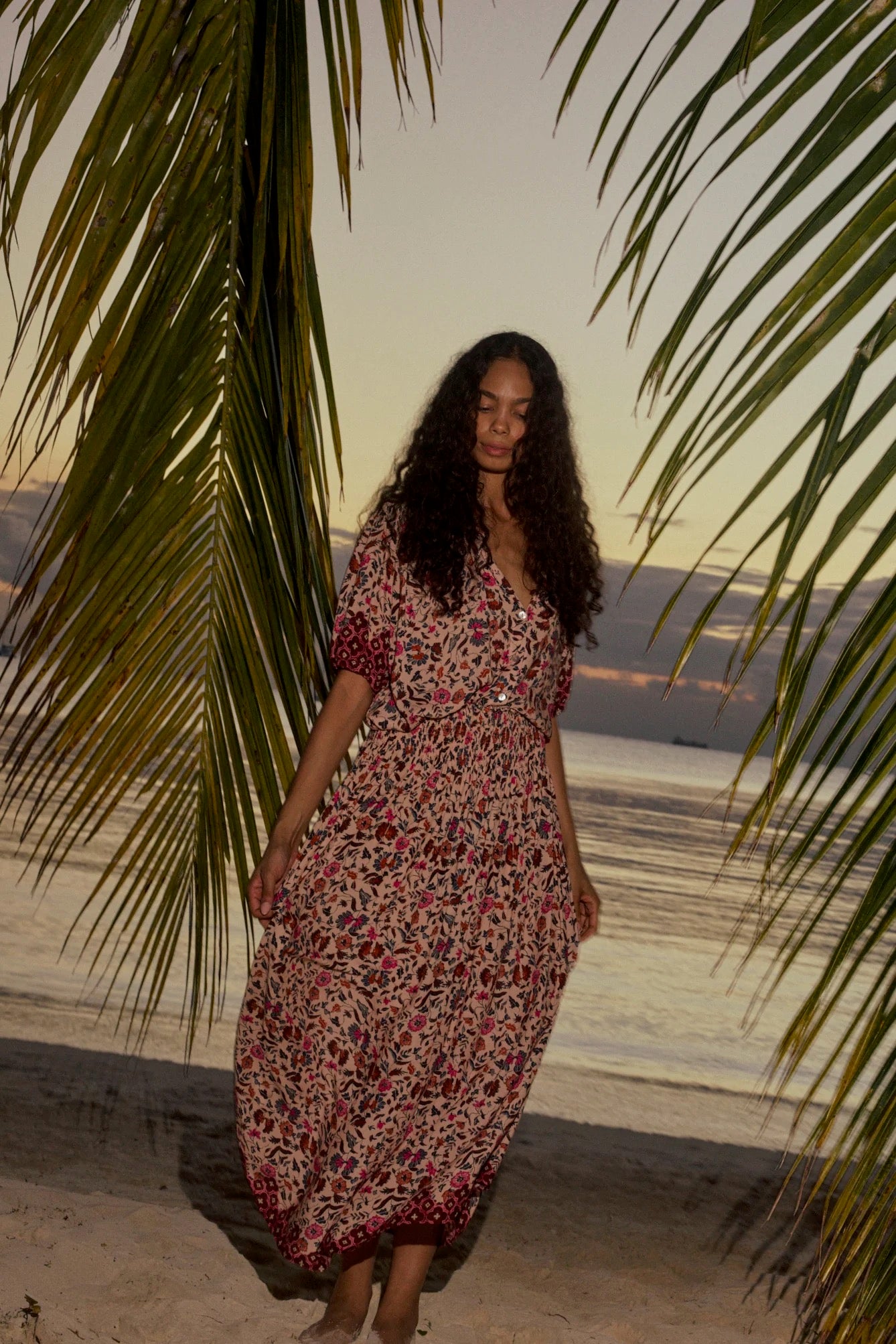 Natalie Martin Bella Skirt Wildflower Spice tropical sunset campaign image with flowing floral skirt and gathered waist