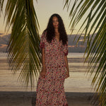Natalie Martin Bella Skirt Wildflower Spice beach campaign image with palm trees and relaxed maxi silhouette