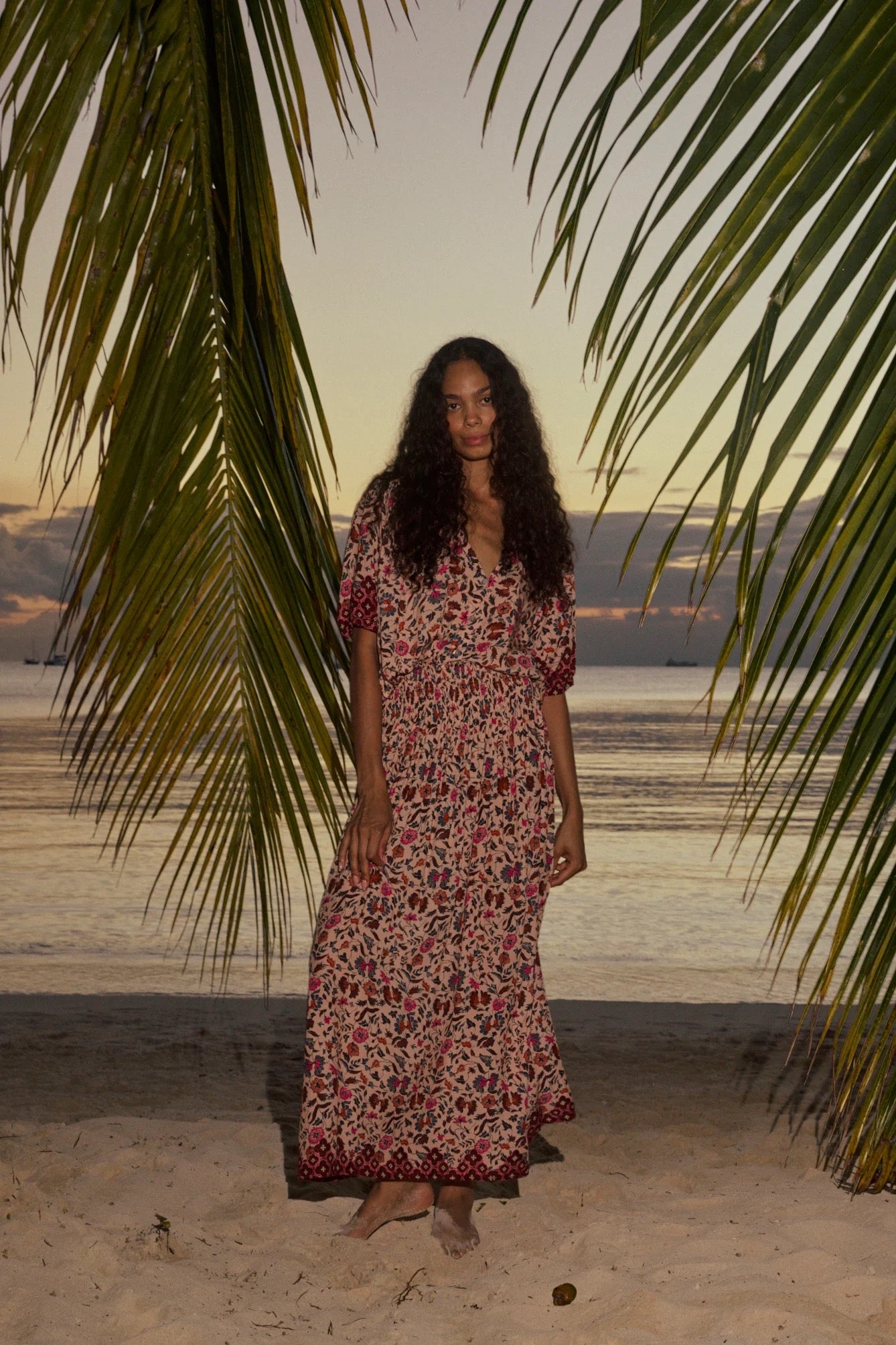 Natalie Martin Bella Skirt Wildflower Spice beach campaign image with palm trees and relaxed maxi silhouette