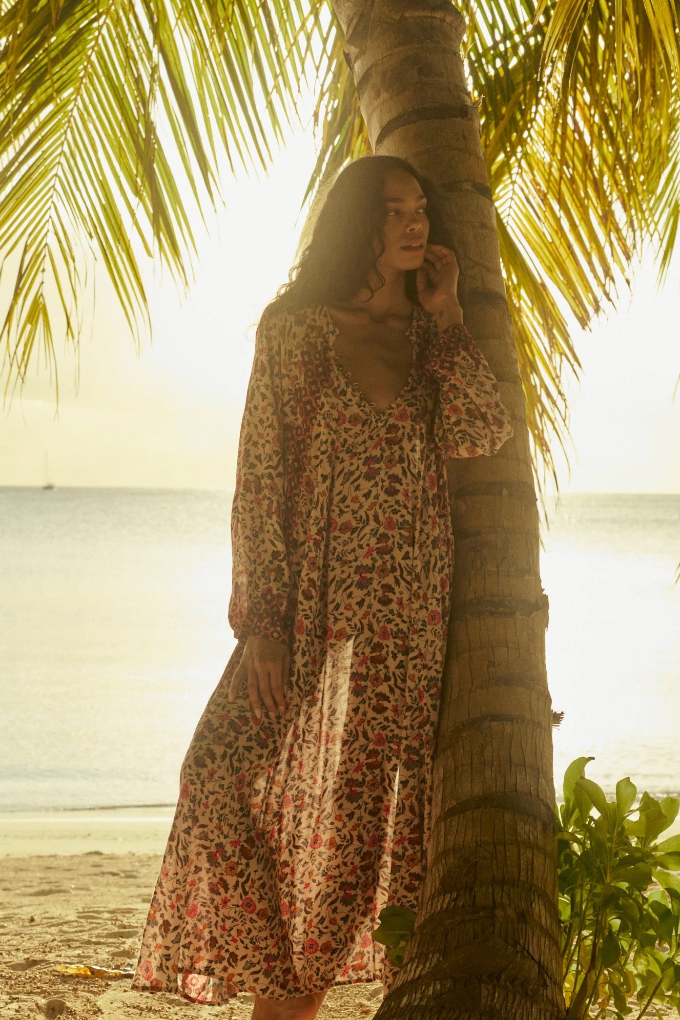 Natalie Martin Fiore Maxi Wildflower Spice resort maxi dress editorial under palm trees at sunset
