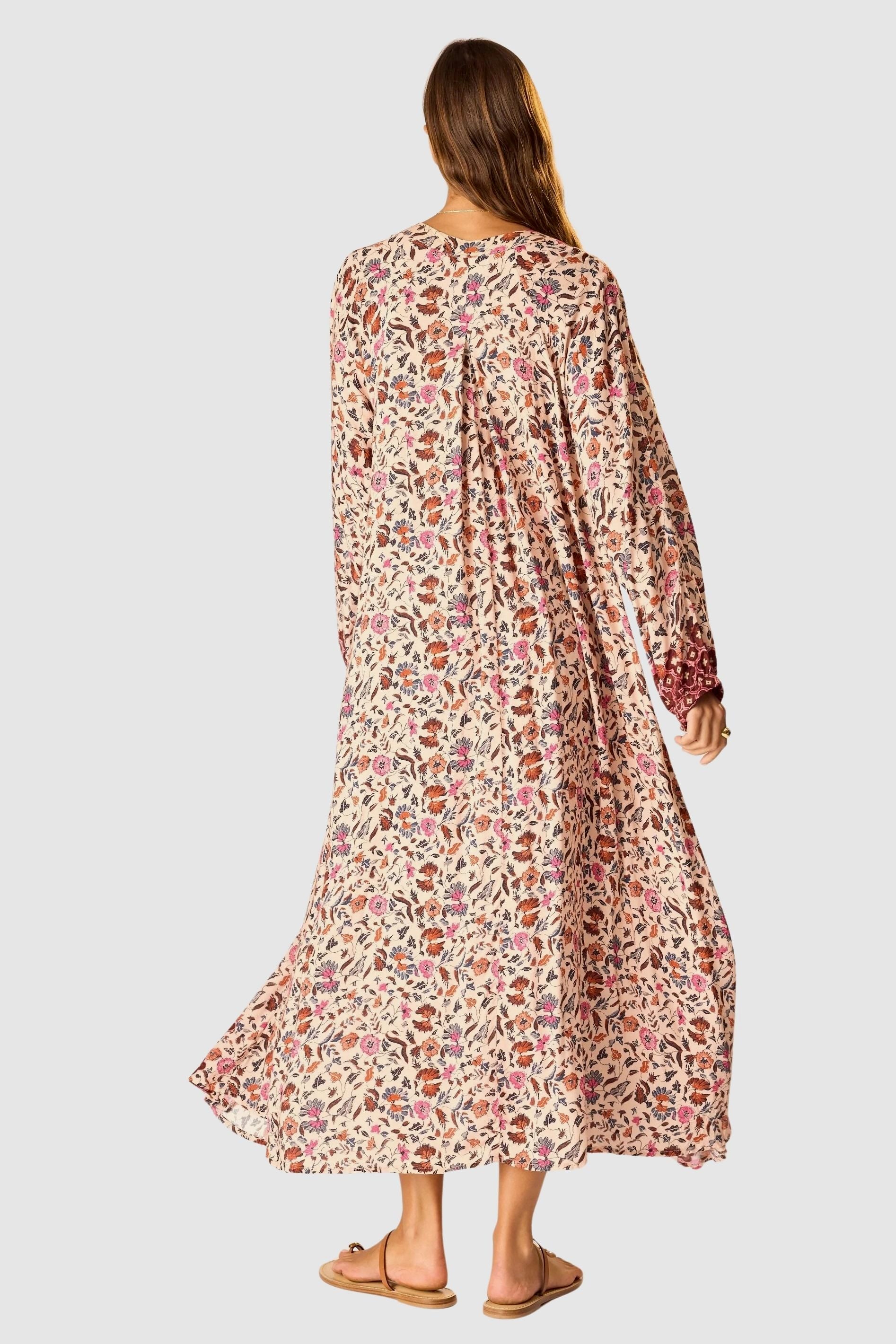 Natalie Martin Fiore Maxi Wildflower Spice floral maxi dress back view with flowing silhouette and long sleeves