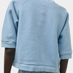 No.6 Emily Sweatshirt Chambray viewed from back with cropped boxy fit and elbow-length sleeves at SHOP YUCCA Denver