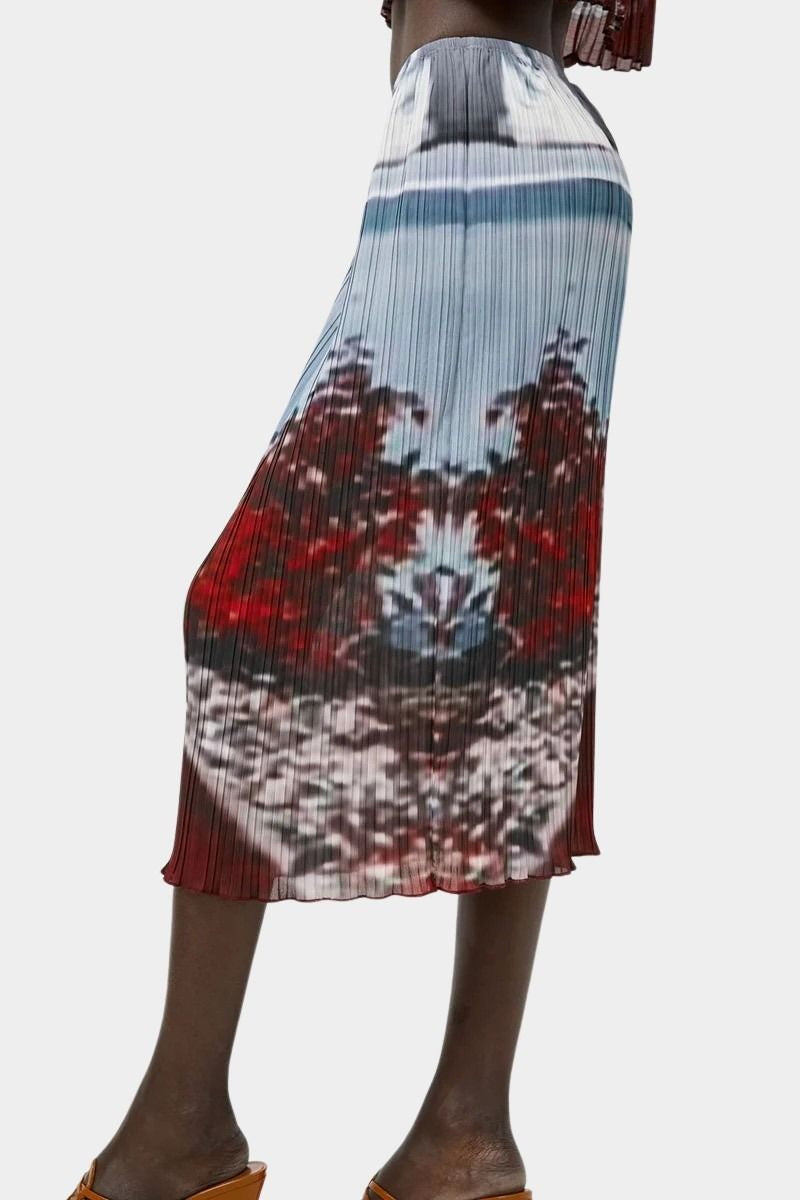 Back side view of No.6 Hiroko pleated midi skirt in Cinema print with elastic waist, airy movement, and abstract red and blue tones