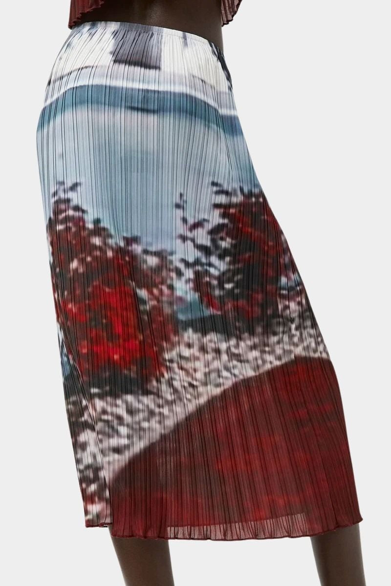 Side view of No.6 Hiroko skirt in Cinema print featuring vertical pleating, blurred landscape imagery, and lightweight midi length