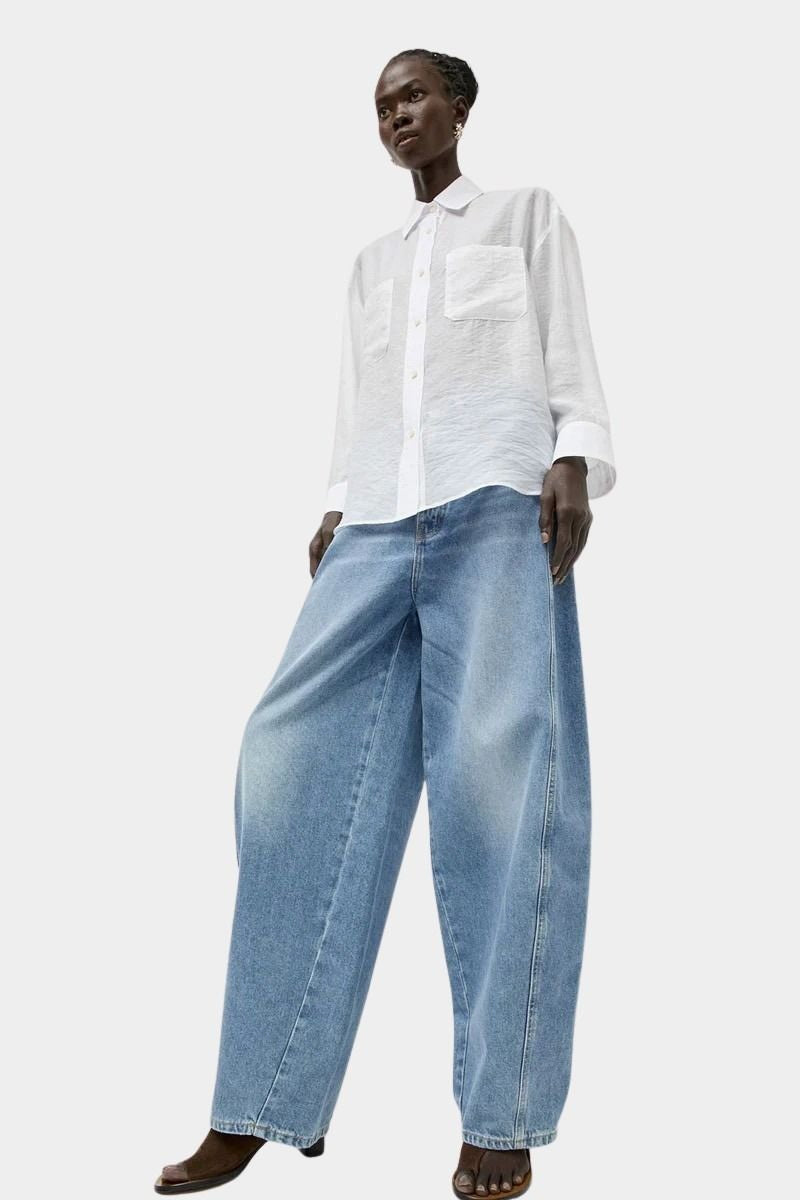 No.6 Lake Shirt in White Organza styled with wide leg light wash denim, featuring a relaxed fit, semi sheer texture, and oversized button-down silhouette.