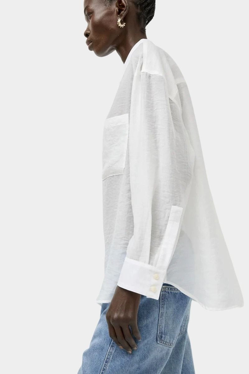 Side profile of the No.6 Lake Shirt in White Organza featuring sheer lightweight fabric, oversized drape, patch pocket detail, and extended cuffs.