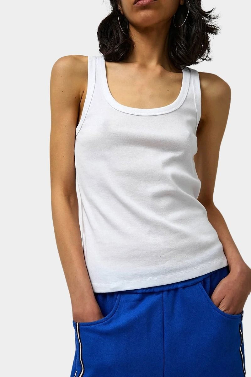 Max Top in White by No.6 white cotton scoop neck tank top with wide straps and slim fit styling paired with cobalt blue track pants
