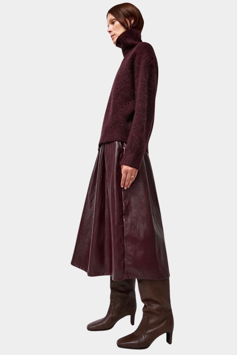 No.6 Mel Skirt in Bordeaux, full side view with a knit sweater and boots