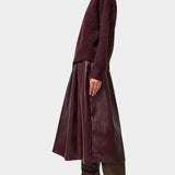 No.6 Mel Skirt in Bordeaux, full side view with a knit sweater and boots