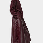 No.6 Mel Skirt in Bordeaux, side view styled with a burgundy sweater and tall boots