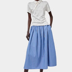 No.6 Mel Skirt in Eton Stripe blue and white striped cotton midi skirt styled with cream polo and white sunglasses full look