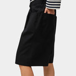 No.6 Mick Short in black cotton ripstop high-rise bermuda shorts side view with hand in pocket styled with striped long sleeve top