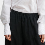 Rachel Comey Ashbolt pant in black, close-up detailing elastic drawstring waistband and textured fabric