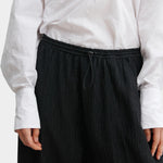 Rachel Comey Ashbolt pant in black, close-up detailing elastic drawstring waistband and textured fabric