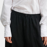 Rachel Comey Ashbolt pant in black, close-up detailing elastic drawstring waistband and textured fabric