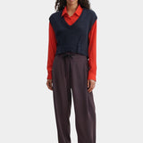 Rachel Comey navy V-neck knit vest layered styling with wide leg trousers