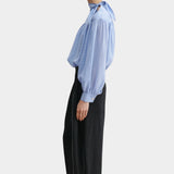 Rachel Comey Dini pant in black, side profile showing clean tailored line and subtle volume through the leg