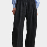 Rachel Comey Dini pant in black with high waist, wide-leg silhouette, and soft front pleating, styled with blue blouse