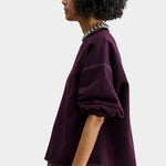 Rachel Comey Fond Sweatshirt Plum side view with dropped shoulder and raw edge hem