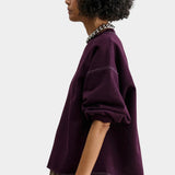Rachel Comey Fond Sweatshirt Plum side view with dropped shoulder and raw edge hem