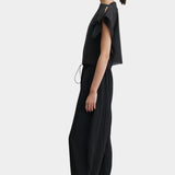 Rachel Comey Rivera Top Black, side profile view highlighting relaxed fit, cropped silhouette, and pleated fabric