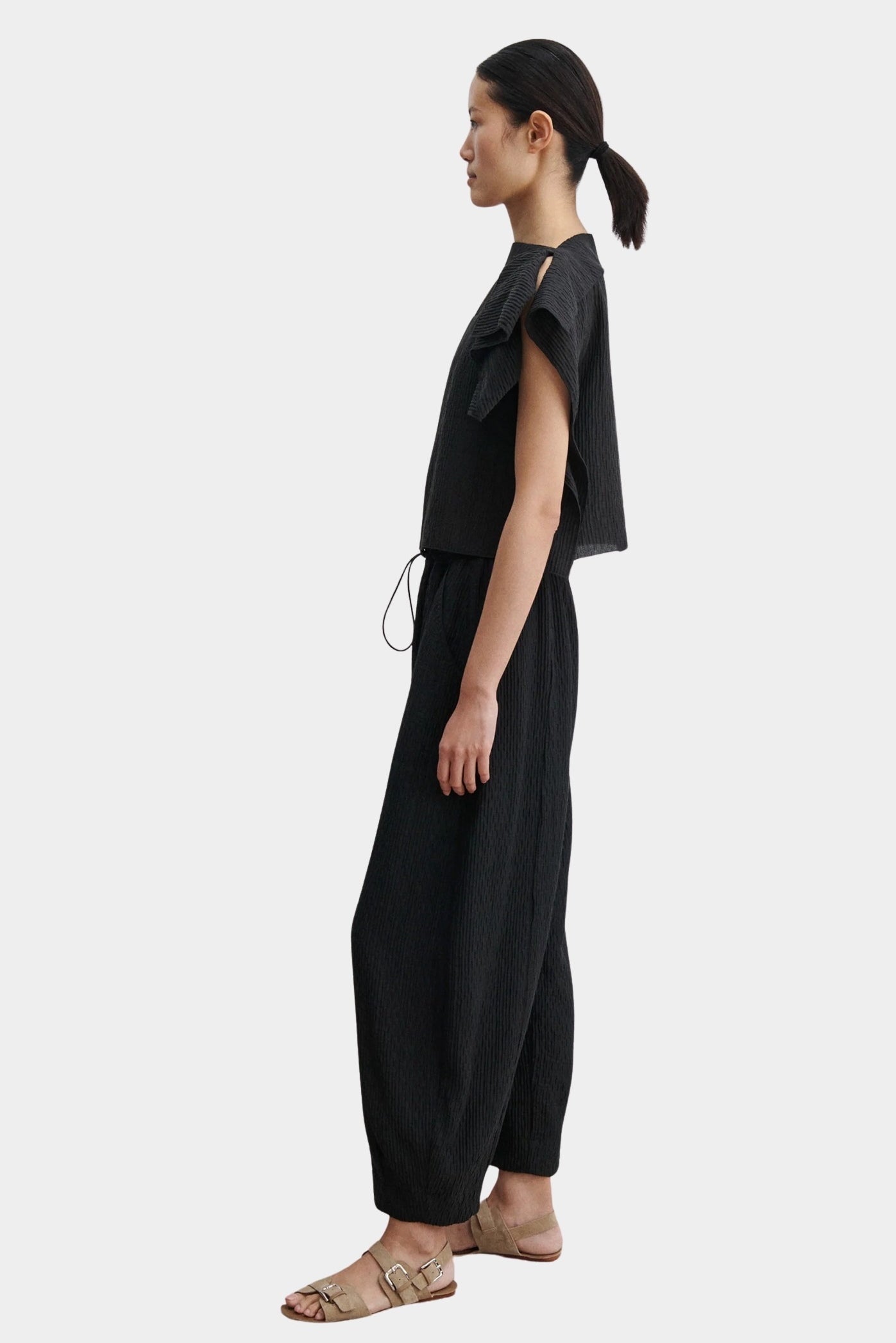 Rachel Comey Rivera Top Black, side profile view highlighting relaxed fit, cropped silhouette, and pleated fabric