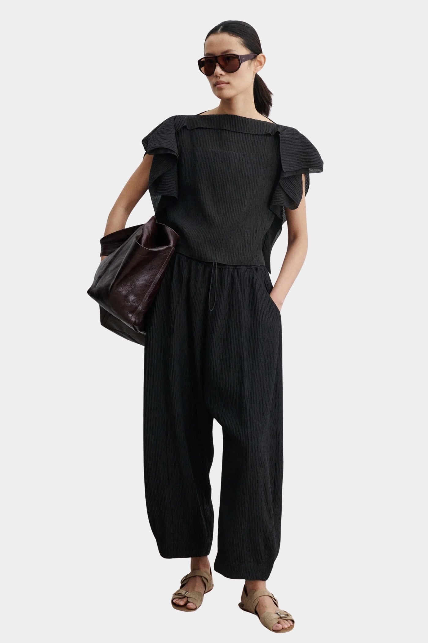 Rachel Comey Rivera Top Black, full outfit front view styled with matching black pleated pants and oversized tote