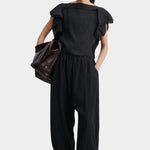 Rachel Comey Rivera Top Black, full outfit front view styled with matching black pleated pants and oversized tote