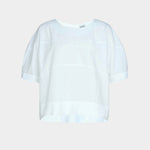 Rachel Comey rugby top in white cotton, flat lay showing boxy silhouette, clean neckline, and subtle seam construction
