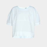 Rachel Comey rugby top in white cotton, flat lay showing boxy silhouette, clean neckline, and subtle seam construction