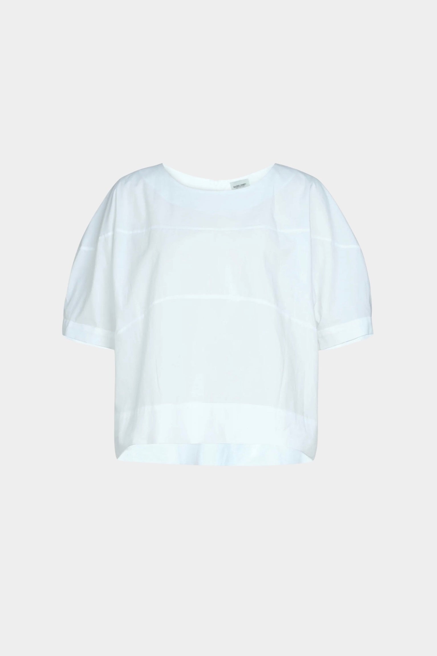 Rachel Comey rugby top in white cotton, flat lay showing boxy silhouette, clean neckline, and subtle seam construction