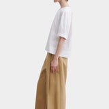 Rachel Comey rugby top in white cotton, side profile highlighting relaxed drape and slightly cropped length