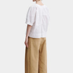 Rachel Comey rugby top in white cotton, back view showing clean structure, relaxed silhouette, and panel construction