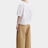 Rachel Comey rugby top in white cotton, back view showing clean structure, relaxed silhouette, and panel construction