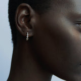 Close-up of RAGBAG Studio Odette Earrings in Gold with sparkling bezel set stones at YUCCA Denver