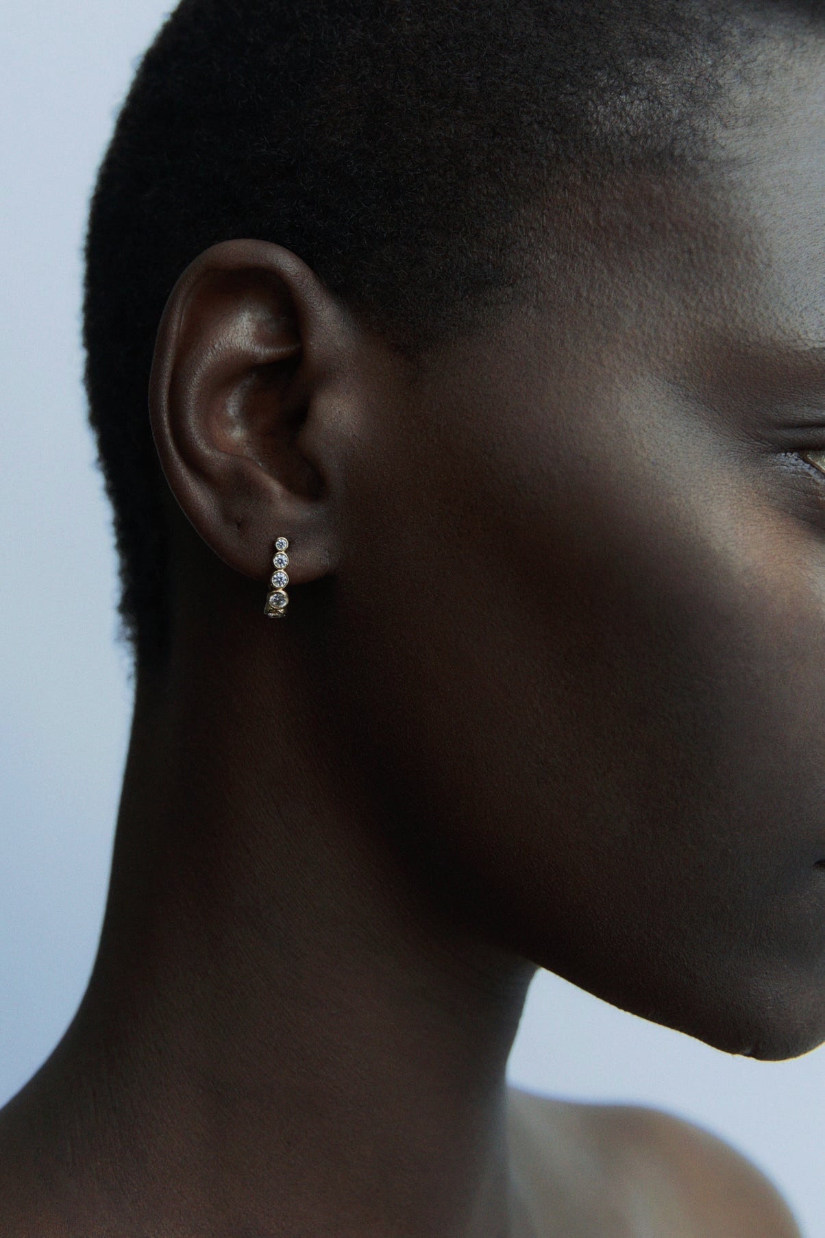 Close-up of RAGBAG Studio Odette Earrings in Gold with sparkling bezel set stones at YUCCA Denver
