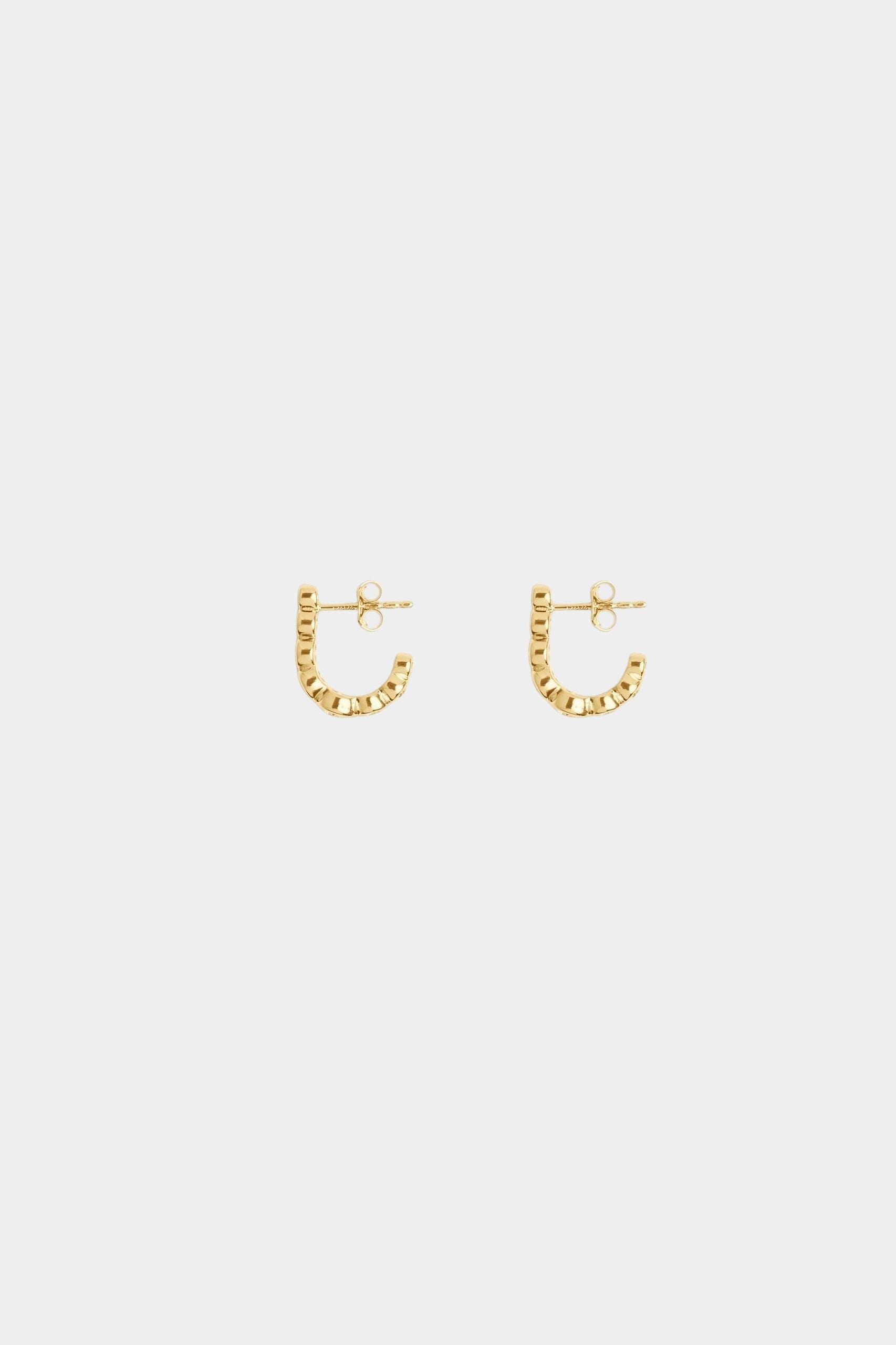 Side view of Odette gold plated sterling silver earrings showing the curved hook shape and polished finish