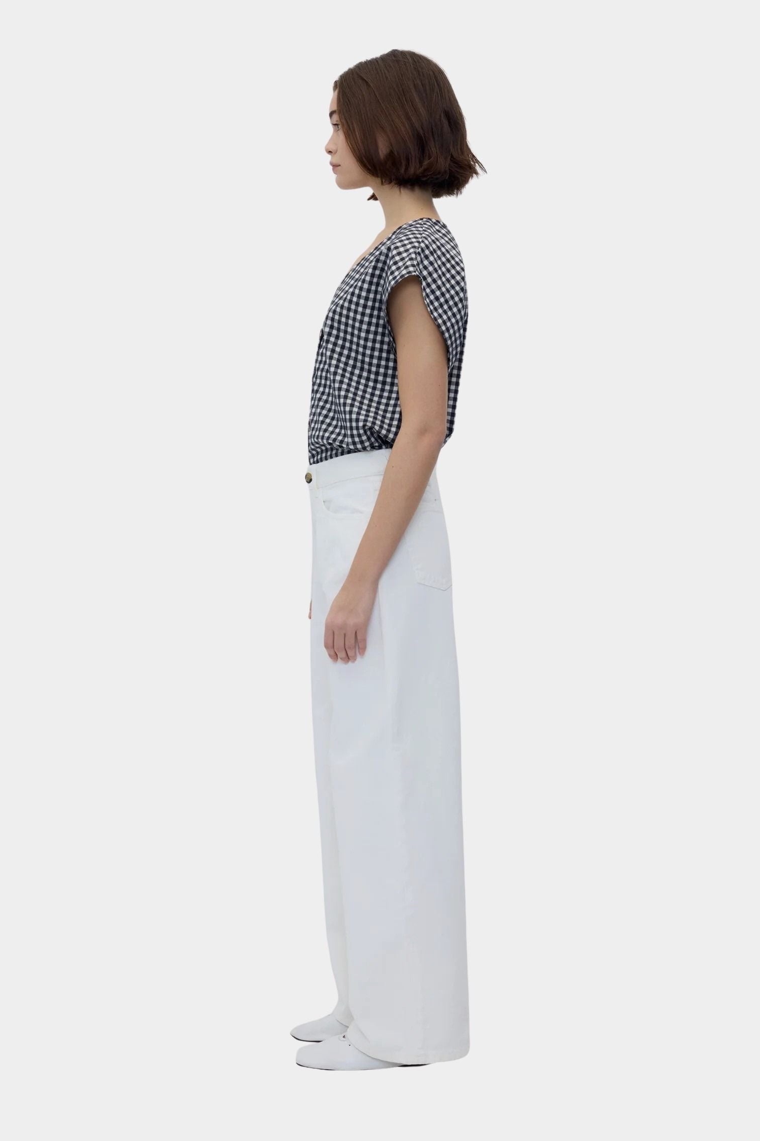 Black gingham cotton V neck top with cap sleeves, side profile view
