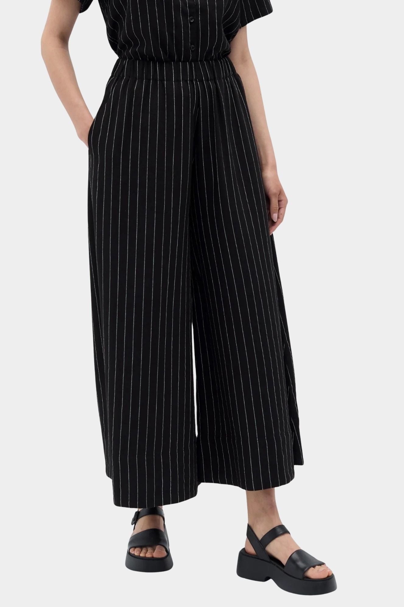 Rita Row Dolors pant in black pinstripe wide leg pants angled front view with elastic waistband and side pockets