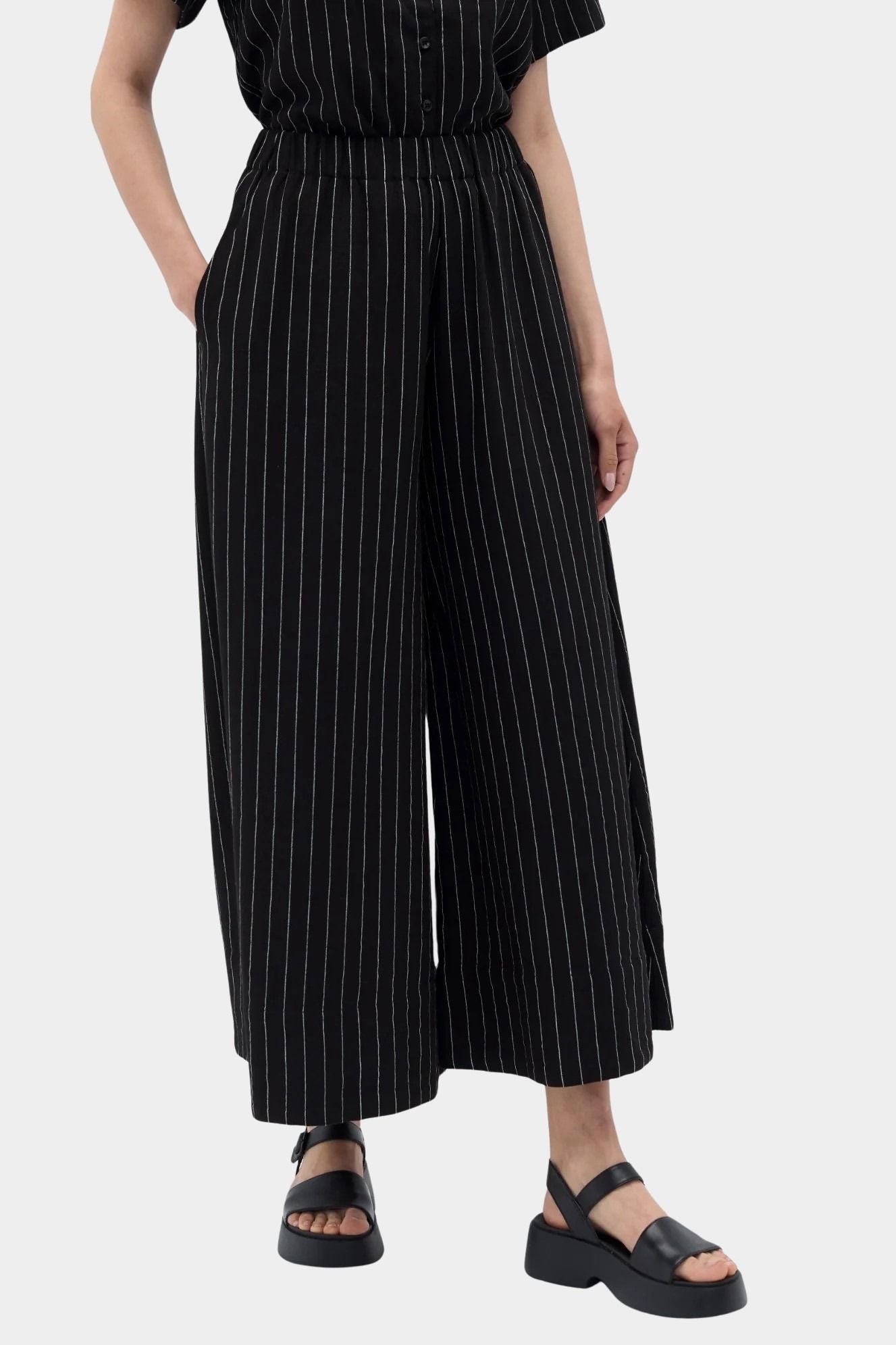 Rita Row Dolors pant in black pinstripe wide leg pants angled front view with elastic waistband and side pockets