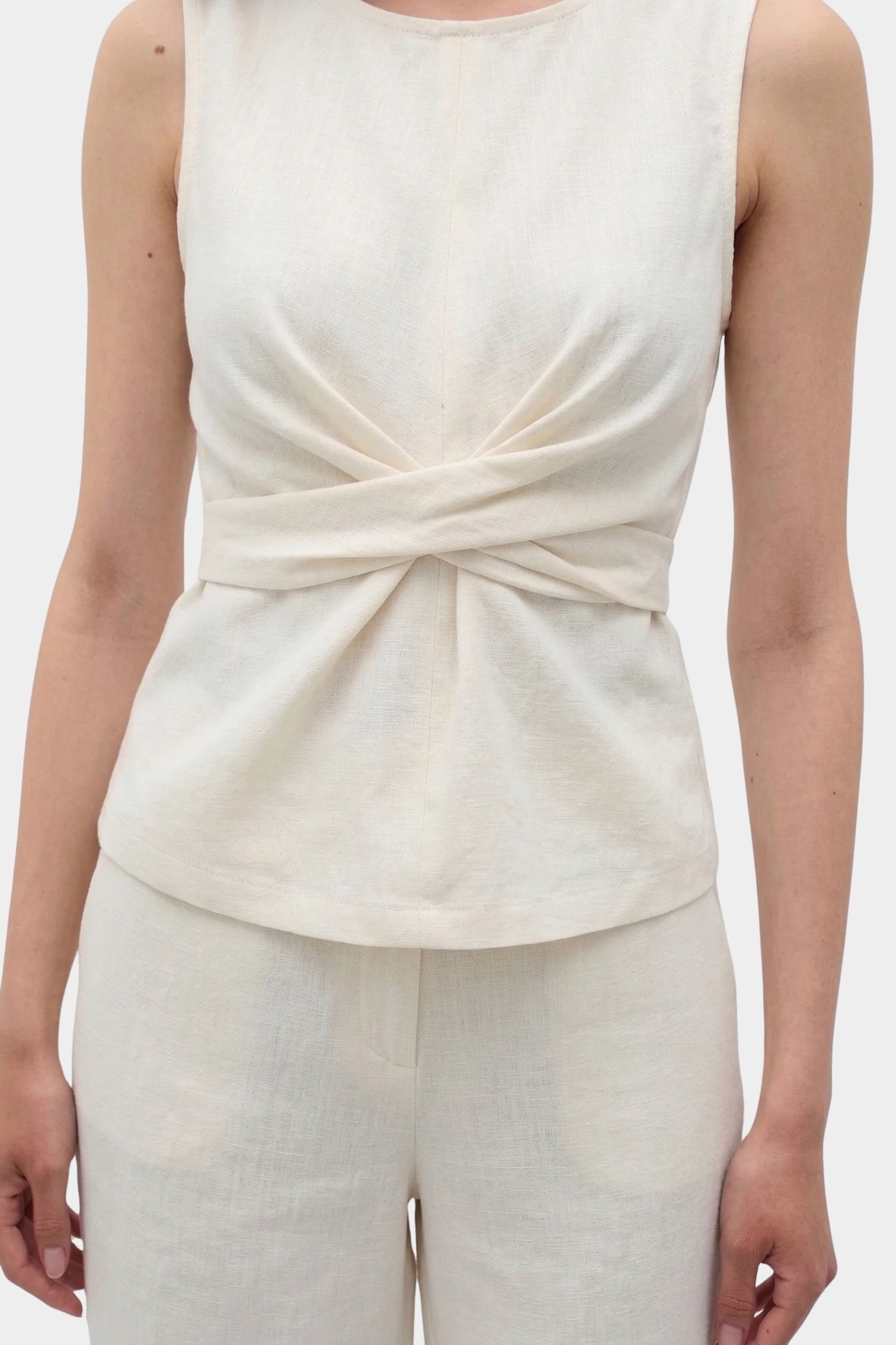 Rita Row Holan top in beige sleeveless top with front wrap waist detail and matching pants front view