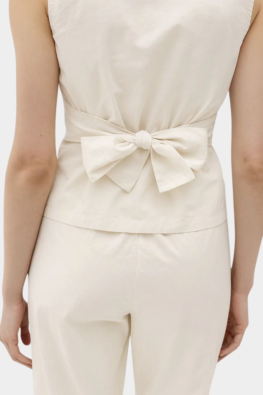 Rita Row Holan top in beige sleeveless top with back bow tie detail and matching pants rear view