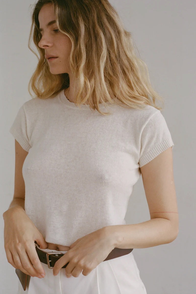 Shaina Mote Baby Tee Chalk fitted short sleeve knit tee styled with ivory trousers and brown leather belt