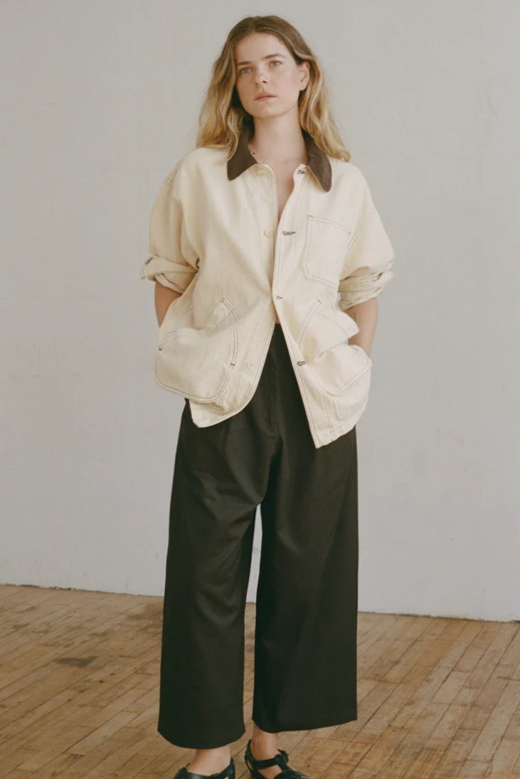 Shaina Mote Painter Coat Butter relaxed canvas jacket styled open with black wide leg pants and minimal leather sandals
