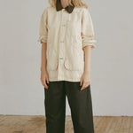 Shaina Mote Painter Coat Butter front view oversized utility jacket with contrast collar and patch pockets styled with black trousers