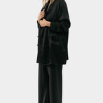 Silk Laundry black silk relaxed blazer worn open with matching trousers